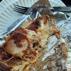 Folded pepperoni slice with a thick, airy crust
