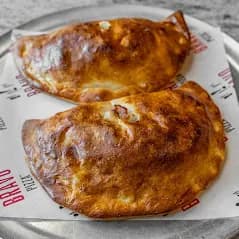 Chicken parm hero cut in half, with sauce and melted cheese